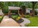 Charming home featuring a brown facade, inviting front porch, landscaped yard, and convenient driveway at 2001 Swazey Dr, Decatur, GA 30032