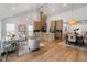 Open-concept living space flows into the kitchen and dining area, featuring hardwood floors and modern lighting at 2001 Swazey Dr, Decatur, GA 30032