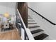 Modern staircase with hardwood steps, contrasting railing and natural light at 2001 Swazey Dr, Decatur, GA 30032