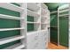 Walk-in closet featuring custom built-in shelving and hardwood floors at 2001 Swazey Dr, Decatur, GA 30032