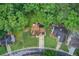 An aerial view features homes surrounded by mature trees and lush landscaping at 1360 Stampmill Way, Lawrenceville, GA 30043