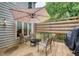 Relaxing back deck featuring comfortable seating, umbrella, and a grill, perfect for outdoor entertaining at 1360 Stampmill Way, Lawrenceville, GA 30043