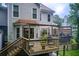 Backyard deck with an outdoor dining area, grill, and wooden railing at 1360 Stampmill Way, Lawrenceville, GA 30043