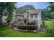 A lovely exterior offers a deck, steps to yard, and lush green lawn at 1360 Stampmill Way, Lawrenceville, GA 30043