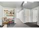 Partially finished basement area with built-in shelving and easy access to other rooms at 1360 Stampmill Way, Lawrenceville, GA 30043