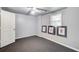 A carpeted bedroom with an overhead ceiling fan, a window for natural lighting, and simple decor at 1360 Stampmill Way, Lawrenceville, GA 30043