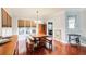 Dining area featuring hardwood floors, a wooden table with benches, and natural light at 1360 Stampmill Way, Lawrenceville, GA 30043