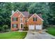 Charming two-story brick home with a well-manicured lawn and attached two-car garage at 1360 Stampmill Way, Lawrenceville, GA 30043