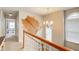 Bright hallway features a decorative chandelier and a unique cowhide rug wall hanging at 1360 Stampmill Way, Lawrenceville, GA 30043