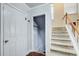 Hallway with carpeted stairs, a convenient closet, and access to other areas of the home at 1360 Stampmill Way, Lawrenceville, GA 30043