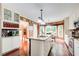 Bright kitchen featuring an island, granite countertops, and white cabinetry at 1360 Stampmill Way, Lawrenceville, GA 30043