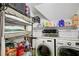 Organized laundry room featuring shelving with cleaning supplies and front loading washer and dryer at 1360 Stampmill Way, Lawrenceville, GA 30043