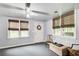 Sunroom-style room features neutral walls, ceiling fan, and bright natural light from multiple windows at 1360 Stampmill Way, Lawrenceville, GA 30043