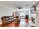 Cozy living room featuring hardwood floors, a fireplace, and comfortable seating at 1360 Stampmill Way, Lawrenceville, GA 30043