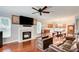 Bright living room with a fireplace, hardwood floors, and a ceiling fan at 1360 Stampmill Way, Lawrenceville, GA 30043