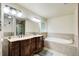 Elegant main bathroom featuring a double vanity, soaking tub, and separate shower for a spa-like experience at 1360 Stampmill Way, Lawrenceville, GA 30043