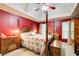 Spacious main bedroom with red walls, tray ceiling and ceiling fan, providing comfort and style at 1360 Stampmill Way, Lawrenceville, GA 30043