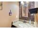 Charming powder room with granite countertop and mosaic tile accent wall, adding a touch of elegance at 1360 Stampmill Way, Lawrenceville, GA 30043