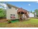 Backyard view showcasing a raised wooden deck and a swing set at 1620 Cedar Hl, Douglasville, GA 30134