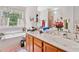 Bright bathroom featuring a double sink vanity and a separate soaking tub at 1620 Cedar Hl, Douglasville, GA 30134