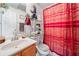Cozy bathroom featuring a red patterned shower curtain and a vanity with chrome faucet at 1620 Cedar Hl, Douglasville, GA 30134