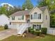 Charming home with a two-car garage, stone accents, and manicured landscaping at 1620 Cedar Hl, Douglasville, GA 30134
