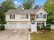 Charming home with a two-car garage, stone accents, and manicured landscaping at 1620 Cedar Hl, Douglasville, GA 30134