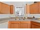 Kitchen featuring wood cabinets, a stainless steel sink, and a bright window at 1620 Cedar Hl, Douglasville, GA 30134