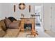 Cozy living area featuring a fireplace, sofa, decorative accents, and easy access to workout equipment at 1620 Cedar Hl, Douglasville, GA 30134