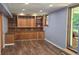 Finished basement area with built-in cabinets, hardwood floors and painted blue walls at 3055 Henderson Mill Rd, Atlanta, GA 30341