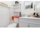 Compact bathroom with a modern vanity and minimalist open shelving for storage at 3055 Henderson Mill Rd, Atlanta, GA 30341