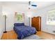 Cozy bedroom with hardwood floors, ceiling fan, and two bedside lamps at 3055 Henderson Mill Rd, Atlanta, GA 30341