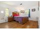 Bedroom features hardwood floors, natural light, and a simple wooden bed frame at 3055 Henderson Mill Rd, Atlanta, GA 30341