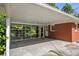 Carport featuring a screened in enclosure, providing a versatile outdoor space adjacent to the house at 3055 Henderson Mill Rd, Atlanta, GA 30341
