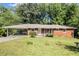 Charming brick ranch-style home with covered carport and a well-manicured front lawn at 3055 Henderson Mill Rd, Atlanta, GA 30341