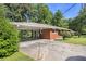 Exterior view showcasing the carport and the well-maintained brick facade of the home at 3055 Henderson Mill Rd, Atlanta, GA 30341