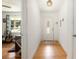 Bright foyer with hardwood floors, featuring a decorative light fixture and a glimpse into the living room at 3055 Henderson Mill Rd, Atlanta, GA 30341