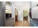Cozy kitchen with wood floors, white tile backsplash, and stainless steel microwave at 3055 Henderson Mill Rd, Atlanta, GA 30341