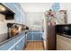 Bright kitchen features blue cabinets, stainless steel refrigerator, and light countertops at 3055 Henderson Mill Rd, Atlanta, GA 30341