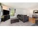 Bright and airy living room with hardwood floors, modern furniture, and a large window overlooking the yard at 3055 Henderson Mill Rd, Atlanta, GA 30341