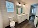 Bathroom featuring double vanity, modern lighting, shiplap, and view into the bedroom at 107 Oconnor Dr, Dallas, GA 30157