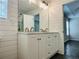 Bathroom featuring double vanity, modern lighting, shiplap walls and view to a glass shower at 107 Oconnor Dr, Dallas, GA 30157
