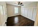 Bright bedroom with dark hardwood floors, paneled accent wall, a ceiling fan, and natural light at 107 Oconnor Dr, Dallas, GA 30157