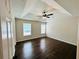 Spacious bedroom features dark wood floors, natural light from windows, and a tray ceiling with a ceiling fan at 107 Oconnor Dr, Dallas, GA 30157