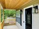 Covered front porch with a black front door and modern lanterns at 107 Oconnor Dr, Dallas, GA 30157