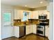 Kitchen features stainless steel appliances, granite countertops and white cabinets at 107 Oconnor Dr, Dallas, GA 30157