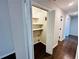 Convenient laundry room with storage shelves and hardwood floors, plus additional wall storage at 107 Oconnor Dr, Dallas, GA 30157