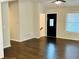 Inviting living room area with dark hardwood floors, a ceiling fan, and a front door entrance at 107 Oconnor Dr, Dallas, GA 30157