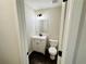 Newly renovated powder room with modern vanity, textured walls, and a water-efficient toilet at 107 Oconnor Dr, Dallas, GA 30157