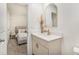 Bathroom featuring a sleek vanity, stylish mirror, and serene atmosphere, adjacent to the bedroom at 1704 Hyssop Se Blvd, Smyrna, GA 30126